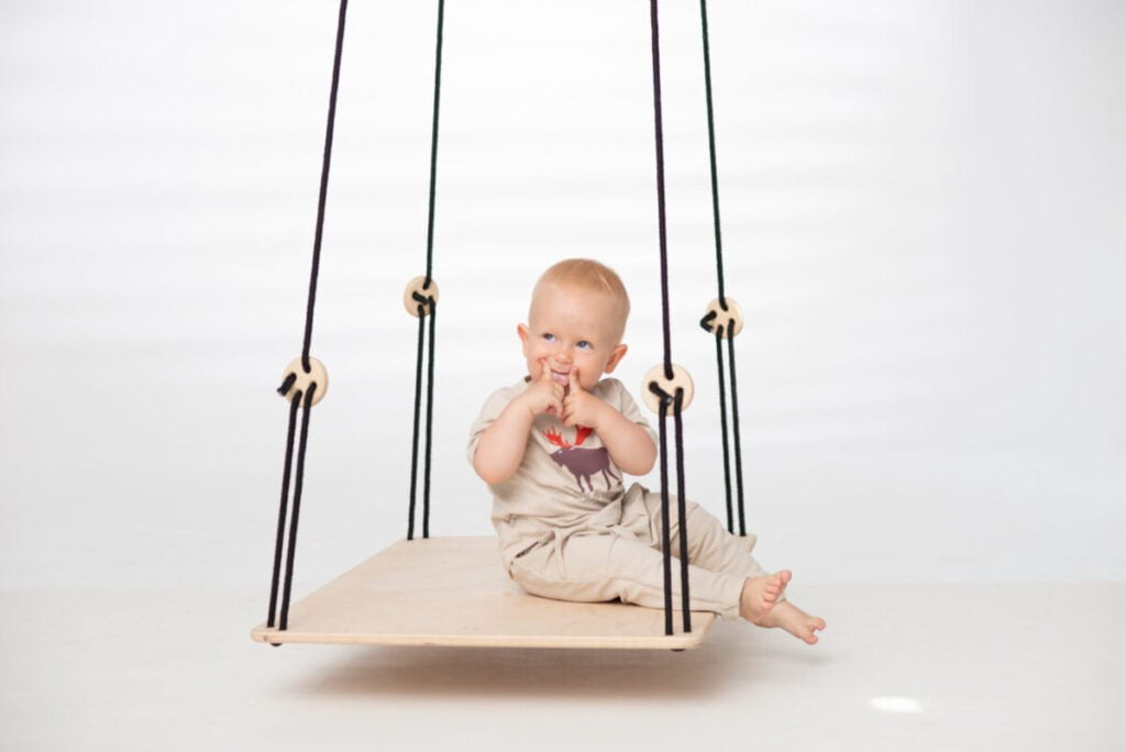 toddler sitting on SENSORY PLATFORM- GOOD WOOD